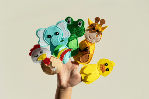 little-girl-playing-with-her-puppets-home